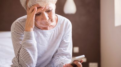 Senior woman seeing no answer on cell phone